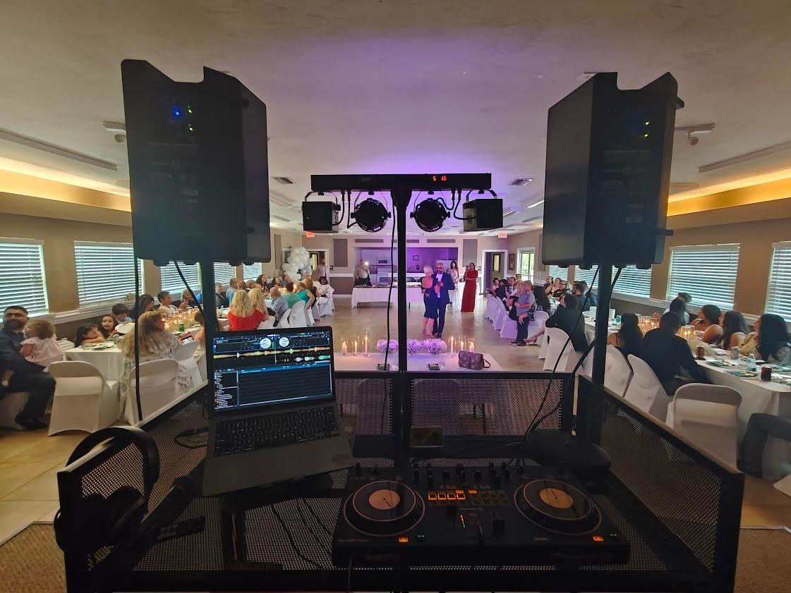 DJ controller, speakers and reactive lighting at a reception